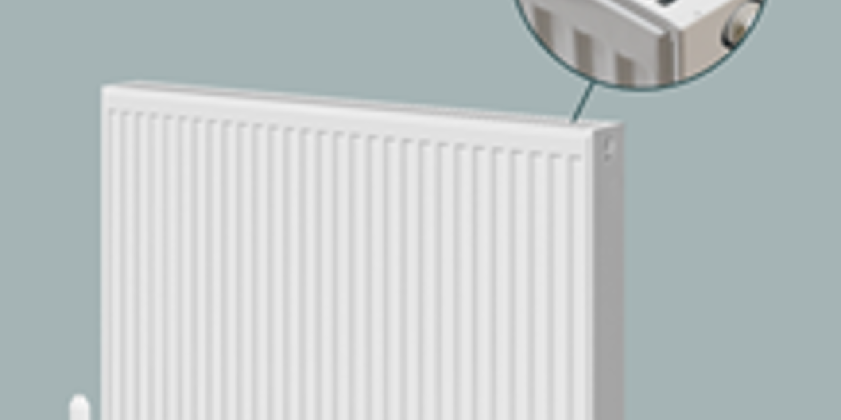 White compact panel radiator with close-up detail of the top grille.